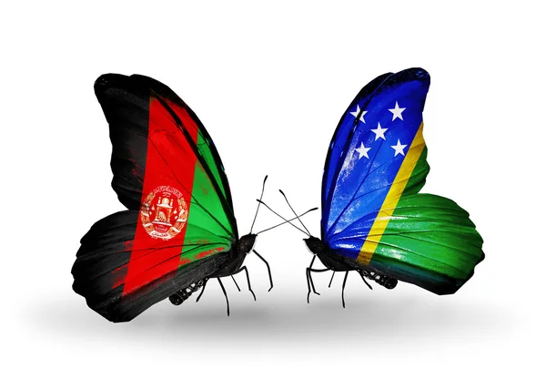 アフガニスタン、ソロモン諸島の国旗と 2 匹の蝶 — ストック写真