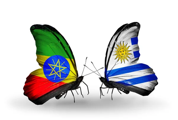 Duas borboletas com bandeiras da Etiópia e Uruguai — Fotografia de Stock