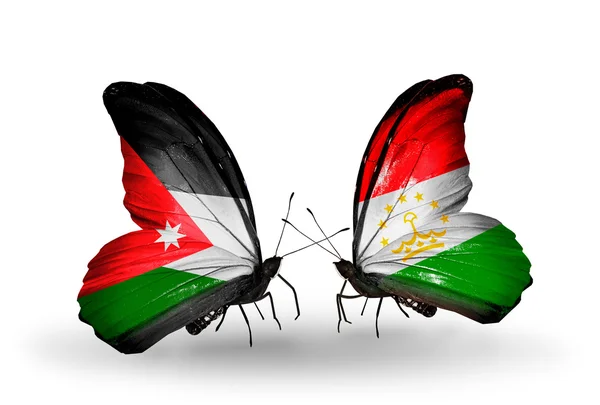 Duas borboletas com bandeiras da Jordânia e do Tajiquistão — Fotografia de Stock