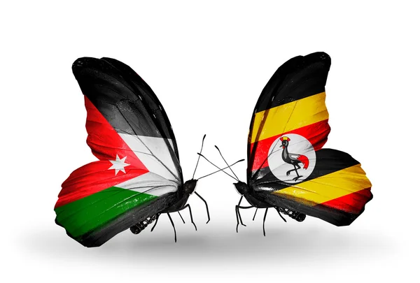 Twee vlinders met vlaggen van Jordanië en Oeganda — Stockfoto