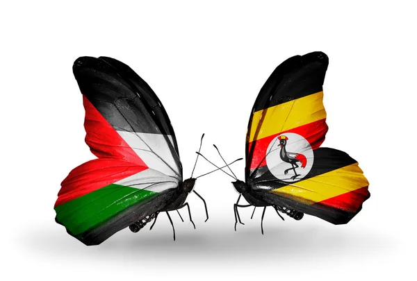 Uganda ve Filistin bayrakları taşıyan iki kelebek — Stok fotoğraf