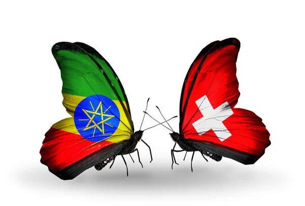 Two butterflies with flags  of Ethiopia and Switzerland — Stock Photo, Image