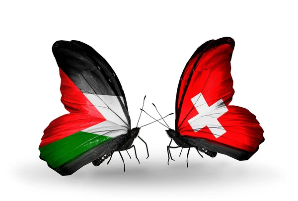 Dwa motyle z flagami Palestyny i Szwajcarii — Zdjęcie stockowe