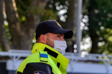 Close Up Of A Policeman At Work During The Rebellion Demonstration Amsterdam The Netherlands 21-9-2020 With A Mouthcap clipart