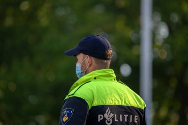 Close Up Of A Policeman At Work During The Rebellion Demonstration Amsterdam The Netherlands 21-9-2020 With A Mouthcap clipart
