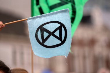 Hollanda 2019 'da, Amsterdam' daki Yok Olma İsyanı 'nın iklim gösterisinde Blauwebrug' da bir bayrağın üzerinde logo.