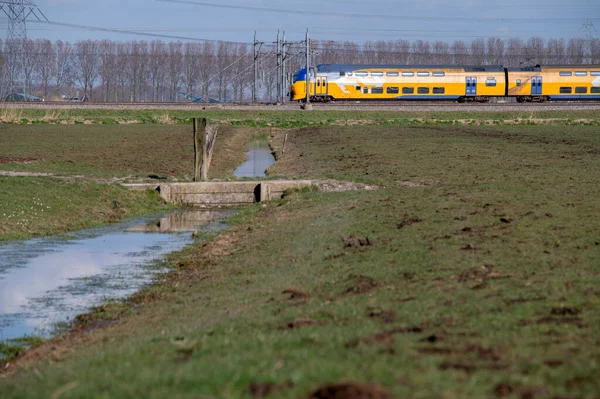 stock image NS Intercity Train Through A Farmfield At Abcoude The Netherlands 15-3-2022