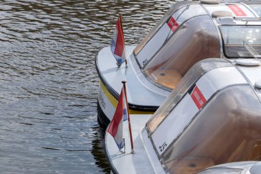 Backside Canal Boats With Dutch Flags At Amsterdam The Netherlands 14-3-2022