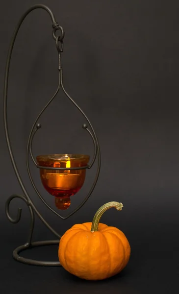Pumpkin and candle halloween studio shot on black background — Stock Photo, Image