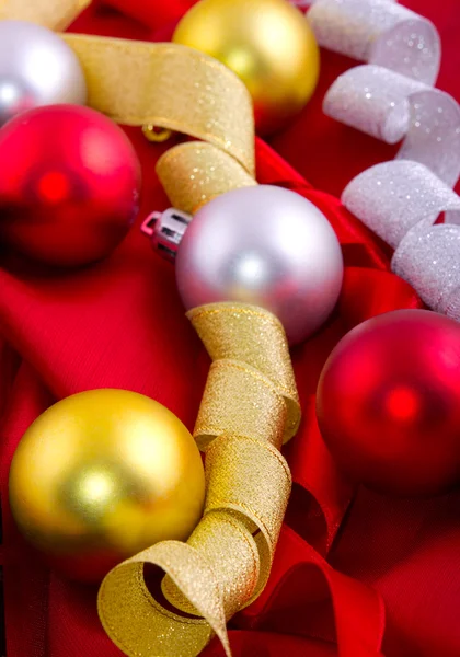 Christmas decoration on a red silk — Stock Photo, Image