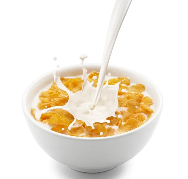 Cornflakes mit Milchspritzer — Stockfoto