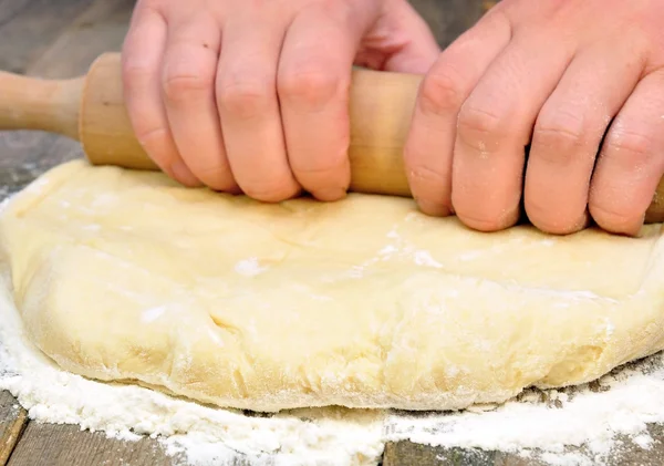 Unrolling dough with a rolling pin — Stock Photo, Image