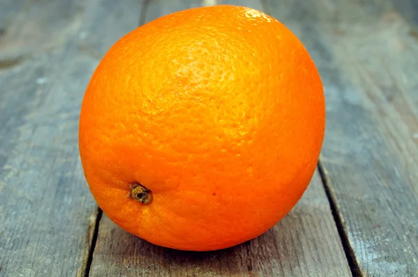 Orange on a wooden table — Stock Photo, Image