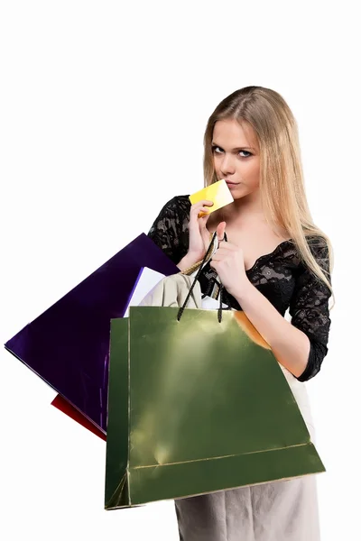 Young girl with paper bags and credit card isolated on white — Stock Photo, Image