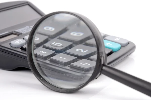 Magnifier and calculator — Stock Photo, Image