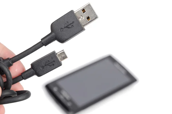 Mobiltelefon och usb på vit bakgrund — Stockfoto