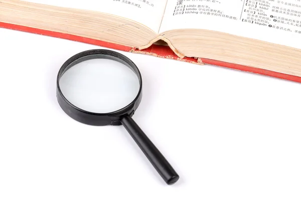 Magnifier and book — Stock Photo, Image