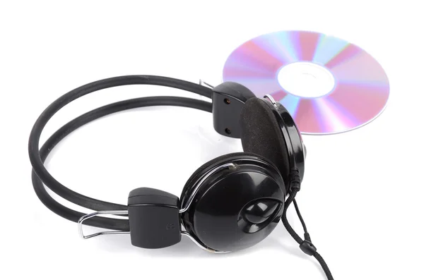 DVD e fone de ouvido em fundo branco — Fotografia de Stock