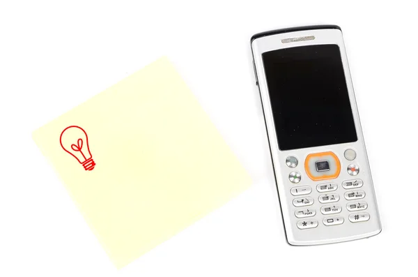 Telefone celular e papel de nota — Fotografia de Stock