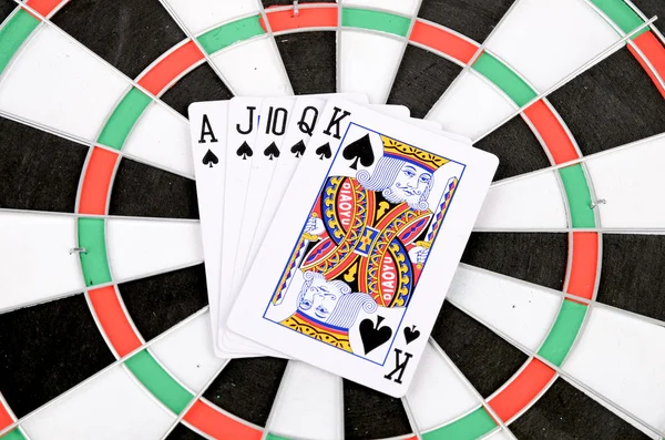 Poker on dartboard — Stock Photo, Image