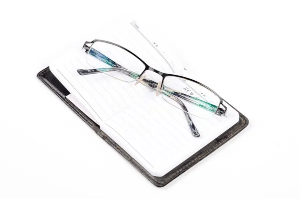 Notebook and glasses Royalty Free Stock Photos