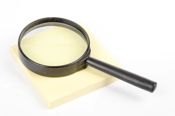 Magnifier and notepaper — Stock Photo, Image