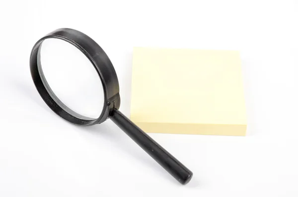 Magnifier and notepaper — Stock Photo, Image