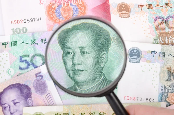 Magnifier and chinese currency — Stock Photo, Image