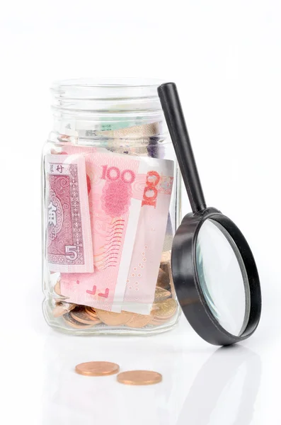 Chinese currency and magnifier — Stock Photo, Image