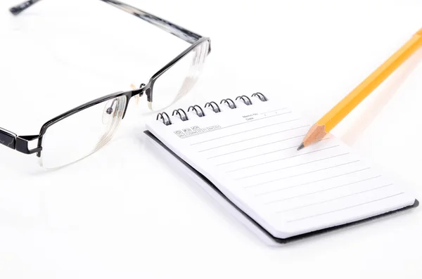 Glasses and pencil with notepad Royalty Free Stock Images
