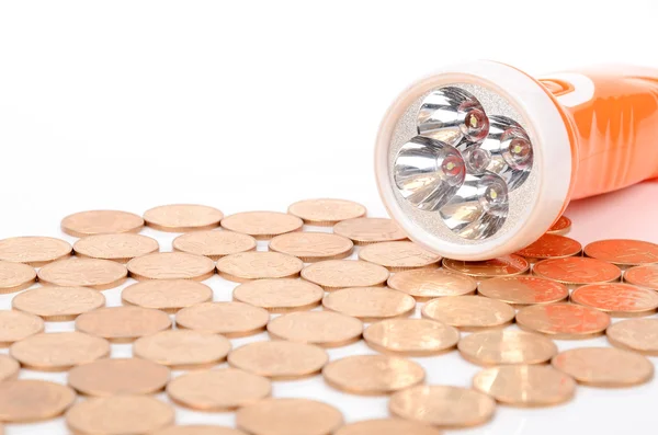 Flashlight and coins — Stock Photo, Image