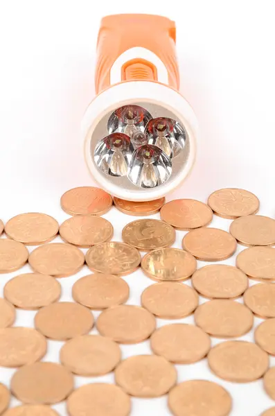 Flashlight and coins — Stock Photo, Image