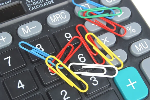 Calculator and paper clip — Stock Photo, Image