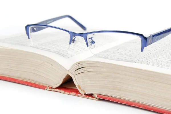 Glasses and dictionary — Stock Photo, Image