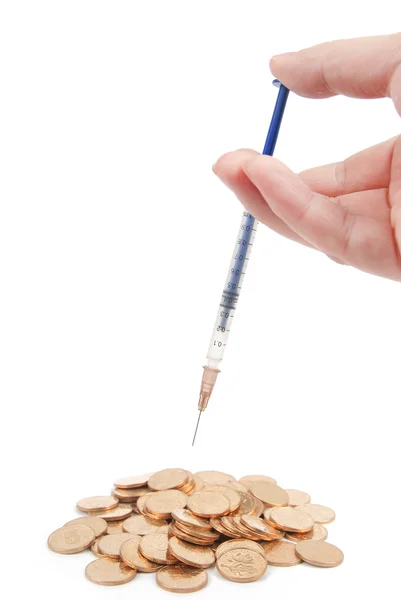 Coins and syringe — Stock Photo, Image