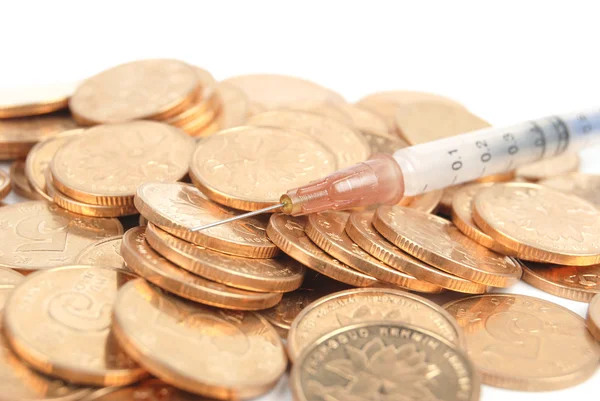 Coins and syringe — Stock Photo, Image