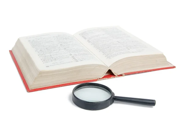 Magnifier and dictionary — Stock Photo, Image