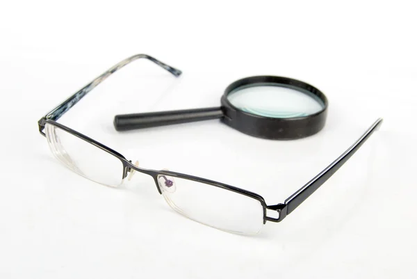 Magnifier and glasses — Stock Photo, Image
