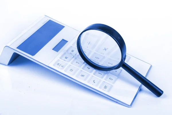 Magnifier and calculator — Stock Photo, Image