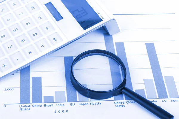 Magnifier and calculator with trend graph Stock Picture