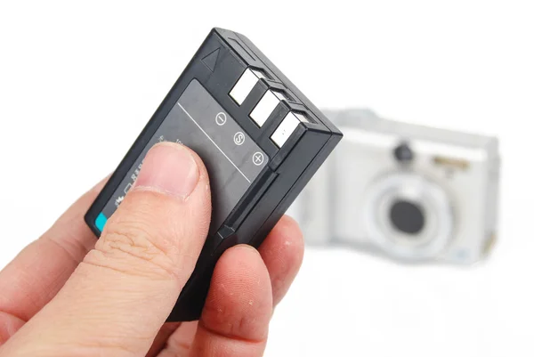 Camera and battery on white background — Stock Photo, Image