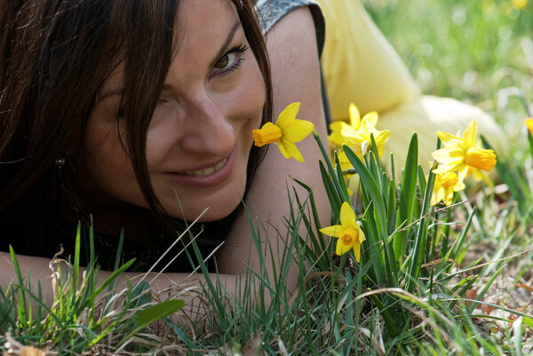 Young woman smelling daffodils