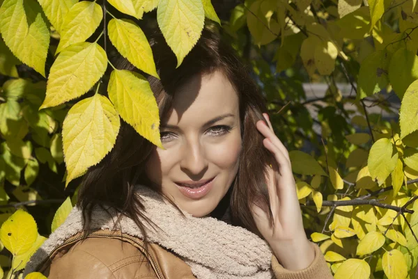 Beautiful woman with yellow leaves — Stock Photo, Image