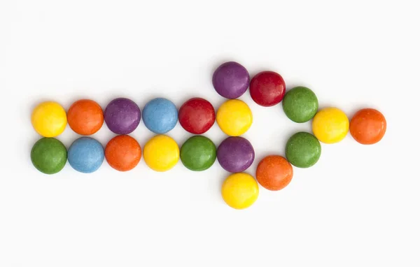 Arrow shape of colorful candies — Stock Photo, Image