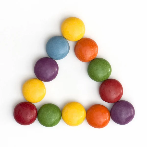 Colorful smarties in a triangle — Stock Photo, Image