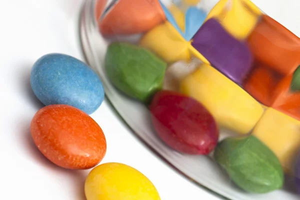 Detail of colorful smarties and glass — Stock Photo, Image