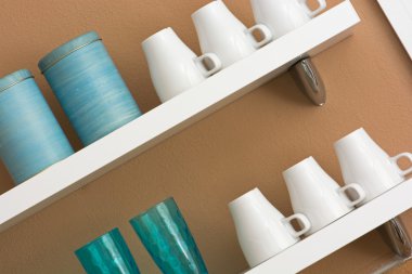 Mugs and cups on the shelf clipart