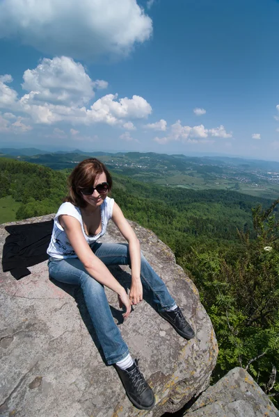 Touriste féminine assise sur le rocher — Photo