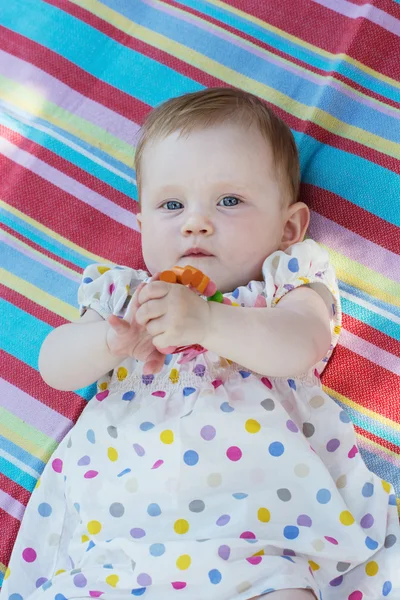 Caucasian little baby girl in multicolored dress — Stock Photo, Image