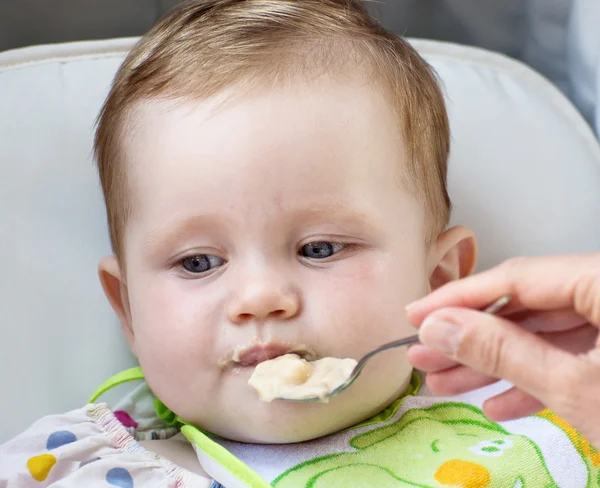 Little baby girl feeding with a spoon — Stock Photo, Image